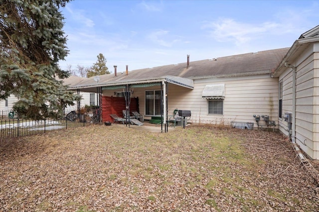 back of property with a patio and fence