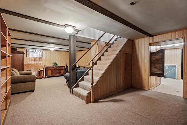 below grade area with stairs, wood walls, and carpet flooring