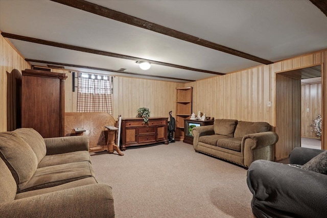 living area featuring wood walls, beamed ceiling, and carpet