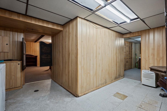 interior space featuring wood walls, electric panel, and tile patterned floors