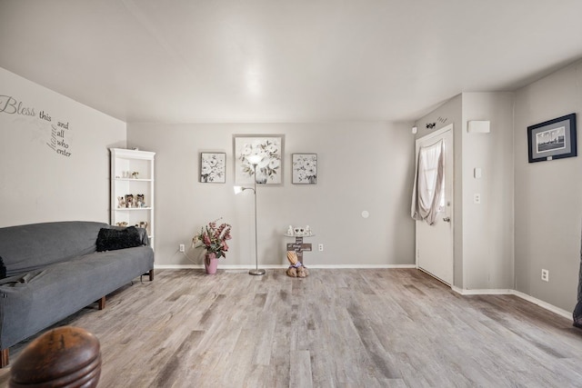 living room featuring baseboards and wood finished floors