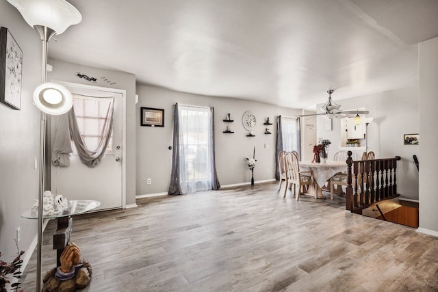 foyer featuring wood finished floors and baseboards