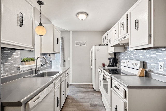 kitchen featuring white appliances, white cabinets, a sink, and under cabinet range hood