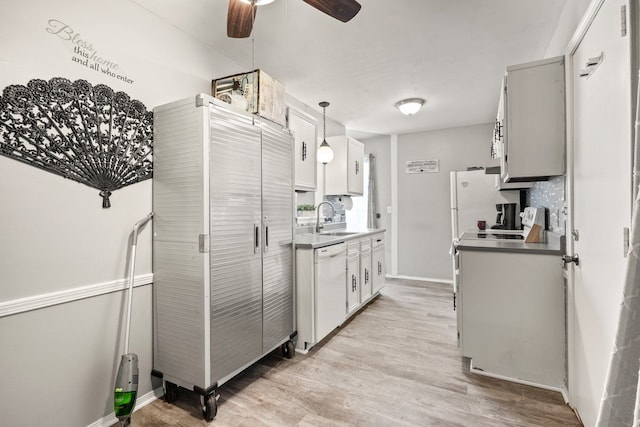 kitchen with light wood-style floors, a sink, ceiling fan, dishwasher, and baseboards