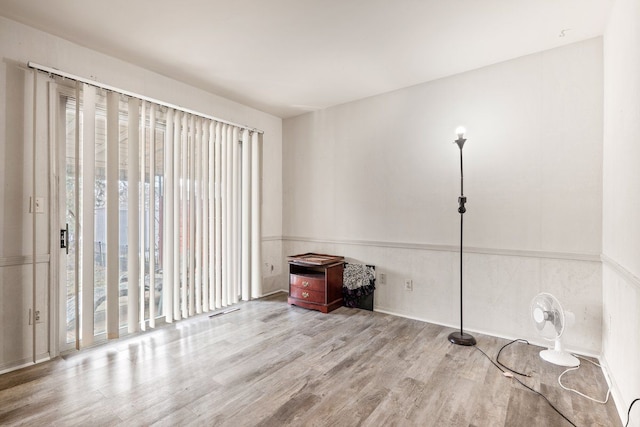 empty room featuring visible vents and wood finished floors