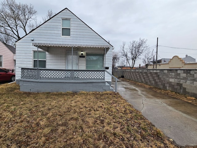 exterior space with covered porch and fence