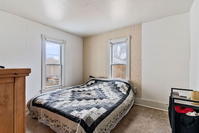 bedroom with multiple windows and carpet flooring