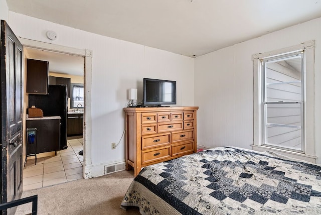 bedroom featuring light carpet and visible vents