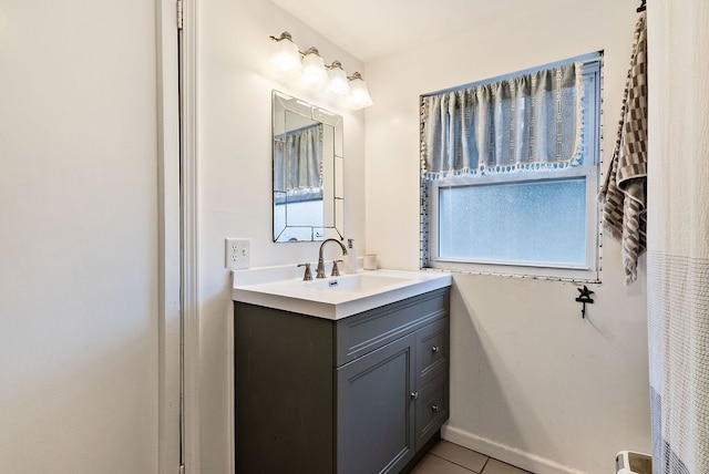 bathroom with tile patterned floors, baseboards, and vanity