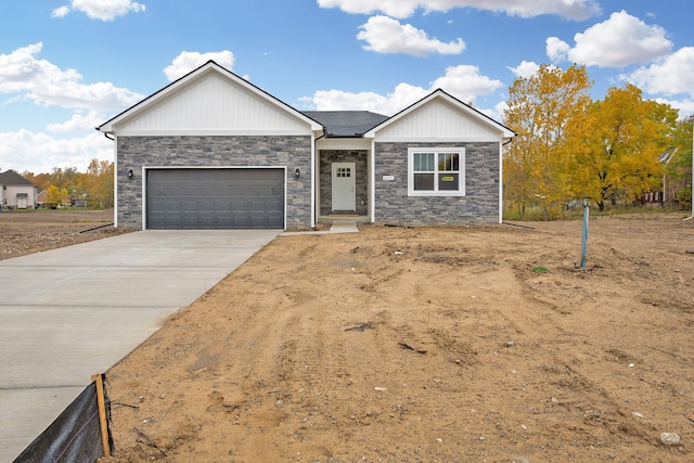 ranch-style house featuring concrete driveway and an attached garage