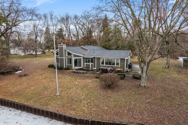 view of front of property featuring a patio and a chimney