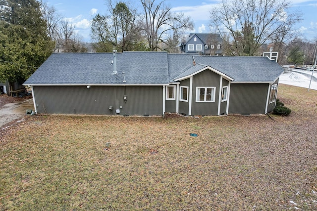 back of property featuring a shingled roof