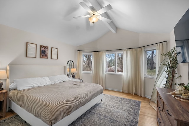 bedroom featuring lofted ceiling with beams, light wood-style floors, ceiling fan, and baseboards