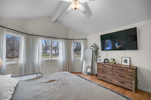 bedroom featuring lofted ceiling with beams, light wood finished floors, a ceiling fan, and baseboards