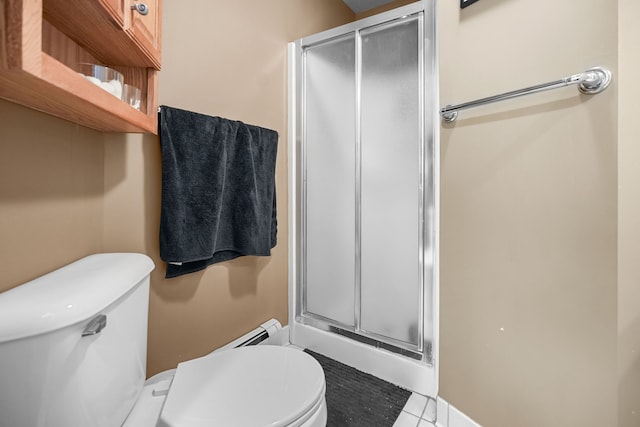 bathroom with a stall shower and toilet