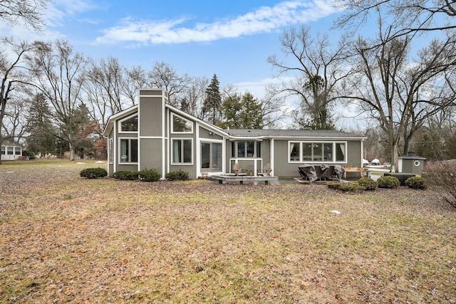 rear view of house featuring a patio and a chimney