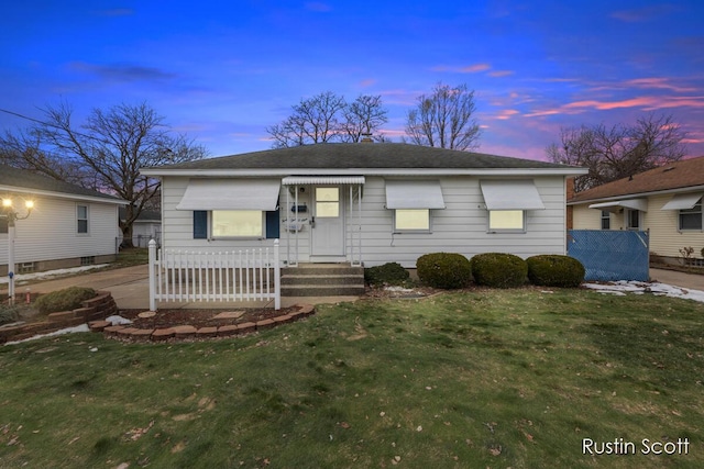 bungalow-style house with a front lawn