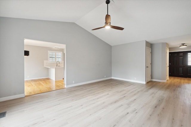 unfurnished living room featuring lofted ceiling, a ceiling fan, baseboards, and wood finished floors