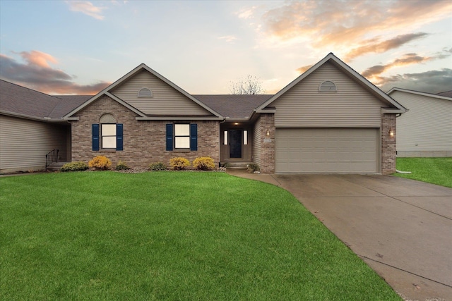 ranch-style house with a front yard, concrete driveway, brick siding, and an attached garage