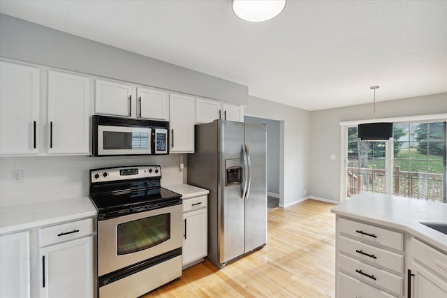 kitchen with stainless steel appliances, tasteful backsplash, and light countertops