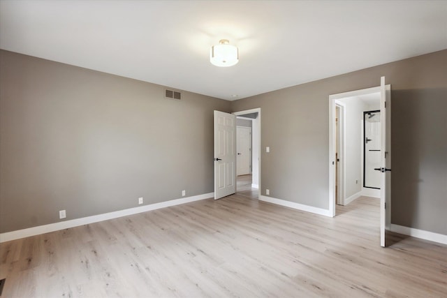 unfurnished bedroom with light wood-type flooring, visible vents, and baseboards