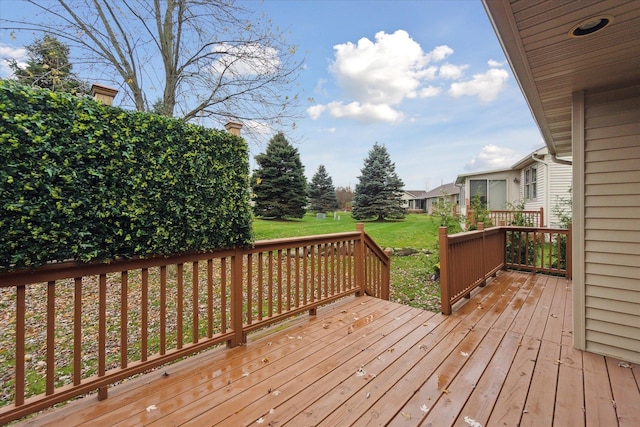 wooden terrace featuring a yard