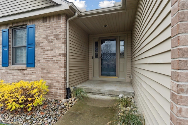 property entrance featuring brick siding