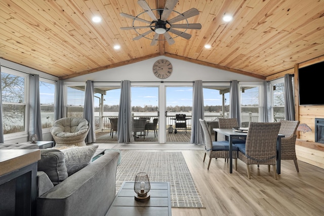 sunroom / solarium with wooden ceiling, vaulted ceiling, and ceiling fan