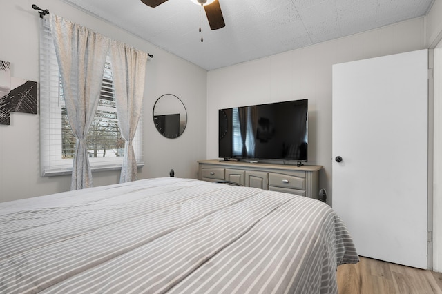 bedroom with light wood-style floors and ceiling fan