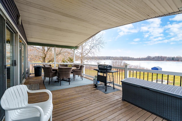 deck featuring a water view, area for grilling, and outdoor dining space