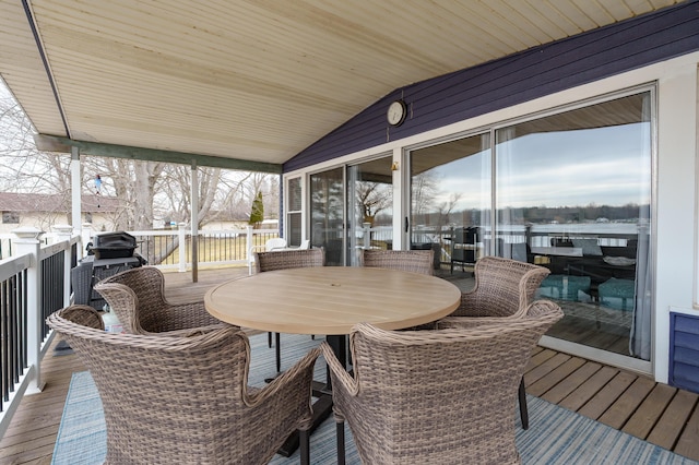 wooden deck with outdoor dining area and grilling area