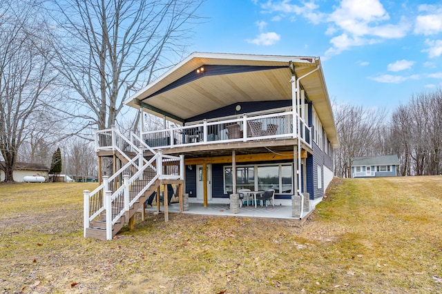 rear view of property with a patio area, stairs, a deck, and a yard