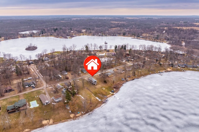 birds eye view of property featuring a forest view and a water view