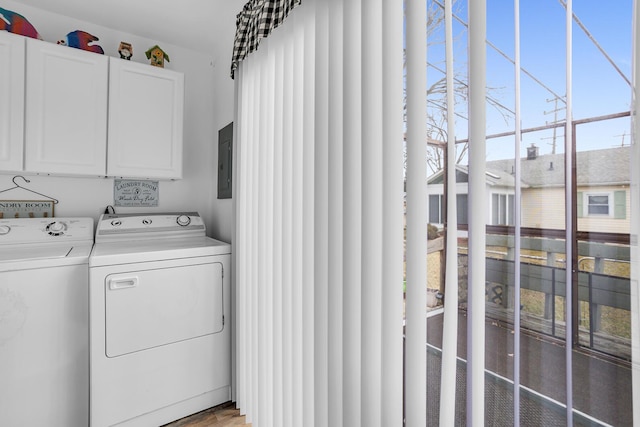 clothes washing area featuring cabinet space, electric panel, and independent washer and dryer