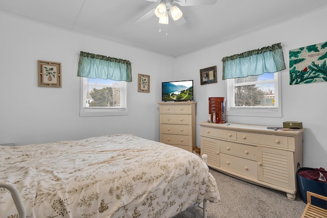 bedroom with light carpet and a ceiling fan