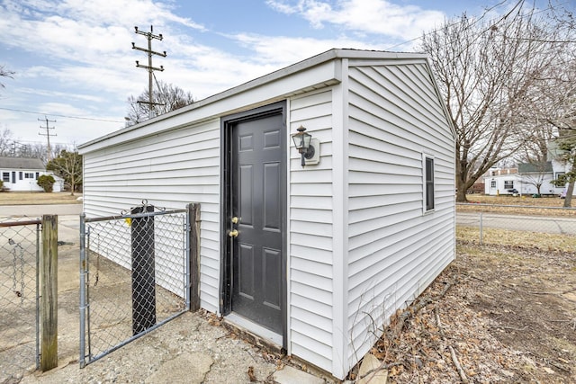 view of outbuilding with fence and an outbuilding