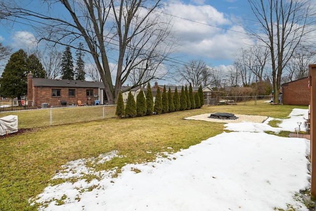 yard covered in snow with a fire pit and a fenced backyard