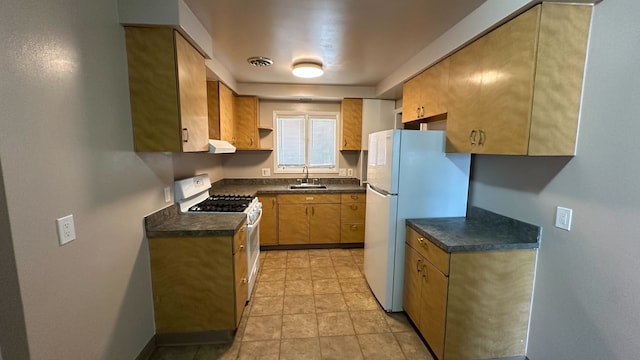 kitchen with dark countertops, visible vents, under cabinet range hood, white appliances, and a sink