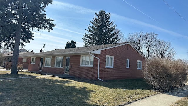 single story home with brick siding and a front lawn