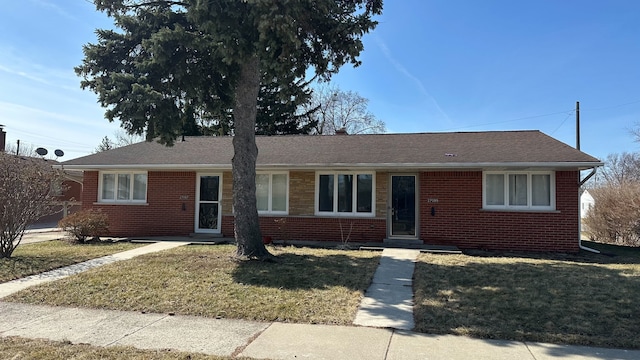 ranch-style home with brick siding and a front yard