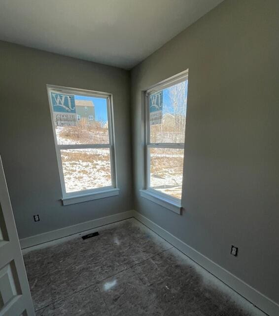 spare room with visible vents and baseboards