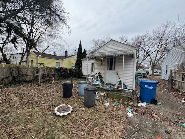 rear view of house featuring fence