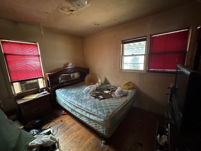 bedroom featuring cooling unit and hardwood / wood-style flooring