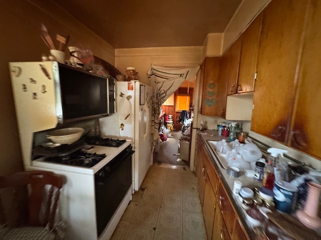 kitchen with gas range gas stove and brown cabinets