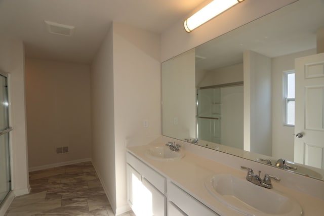 full bath featuring baseboards, a sink, visible vents, and a shower stall