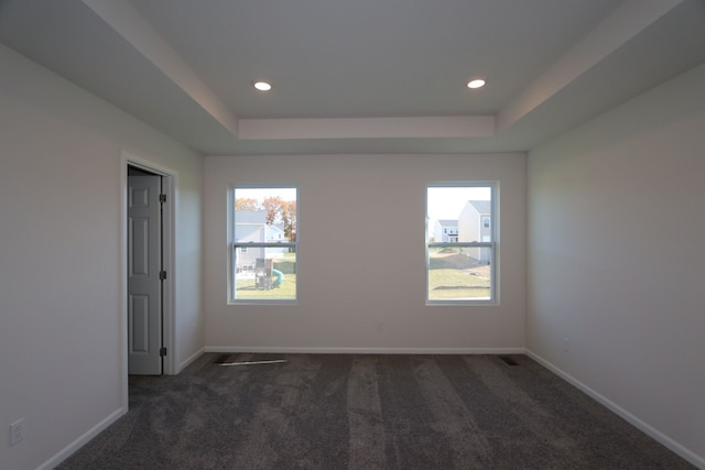 unfurnished room with carpet, a raised ceiling, baseboards, and recessed lighting