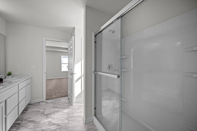 full bathroom featuring vanity, baseboards, marble finish floor, and a stall shower