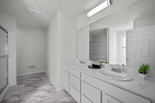 bathroom featuring double vanity, a stall shower, visible vents, and a sink