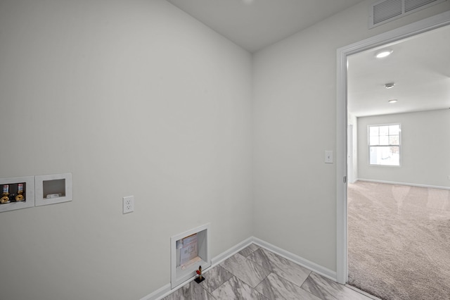 clothes washing area featuring laundry area, visible vents, baseboards, and washer hookup