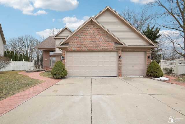 view of front of home featuring a garage, driveway, brick siding, and fence